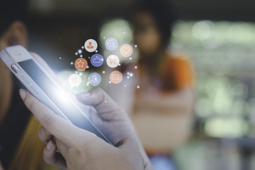 Concept with notification icons of like being happy
and social media interactions on mobile phone,message, email, comment ,businessman hands holding device,smartphone, internet digital marketing.